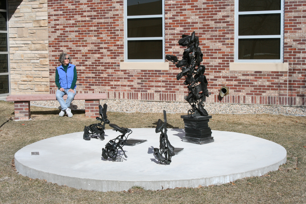 “Tooter”  a public commission for the Laramie County Community College,  Ken Little, 2009;   The concept of the sculpture will be an allegory where animals play the part of students and a professor.  The “professor” will be an adolescent bear standing upright on a foundation or stack of books, as if lecturing or reaching for something.   The “students” around him will be three jackrabbits: one looking at an open book, one sniffing a closed book, and one ignoring it all.  The title would be a word play on tutor or tutoring someone. (The bear and one of the jackrabbits I would be using are already fabricated and pictured here.) You will also notice that my “animals” are made from cast bronze shoes, belts, gloves, extension cords, and other human items.  This gives them a surreal reference to what is the natural world of wild animals and a connection to the civilized world where we use these animals as our food, their skins as our clothing, and so forth.